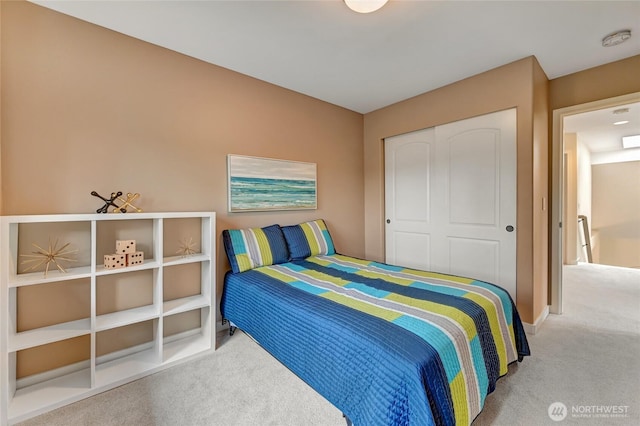 bedroom with carpet and a closet