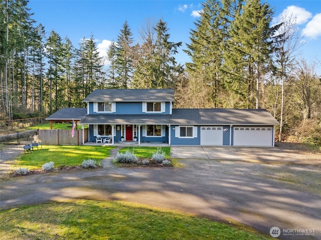 view of front of property featuring dirt driveway, fence, covered porch, a front yard, and a garage