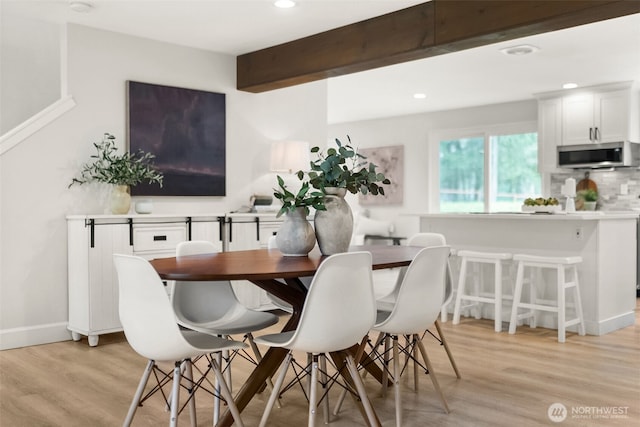 dining space with beam ceiling, recessed lighting, light wood-type flooring, and baseboards