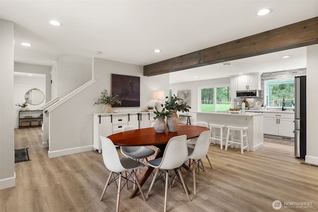 dining space featuring beamed ceiling, recessed lighting, and light wood-type flooring