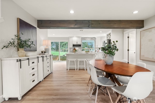 dining room featuring beam ceiling, recessed lighting, and light wood finished floors