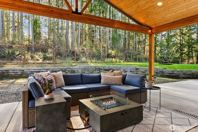 view of patio / terrace with an outdoor living space with a fire pit and a fenced backyard