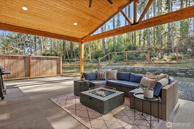 view of patio featuring an outdoor living space with a fire pit and a fenced backyard