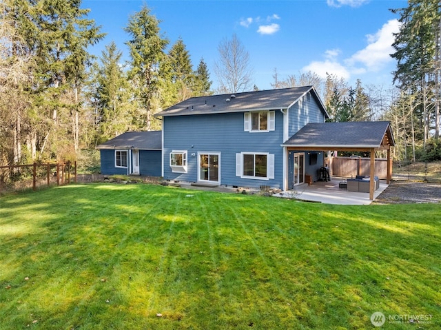 back of property featuring a yard, fence, and a patio area