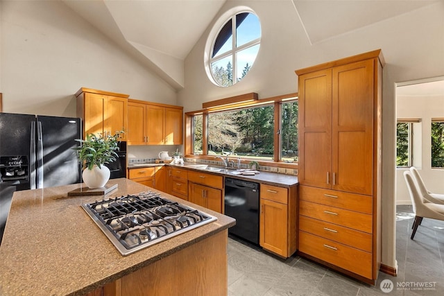 kitchen with a sink, brown cabinets, high vaulted ceiling, and black appliances