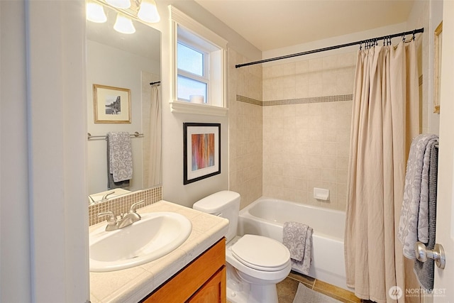 full bath with shower / bath combo with shower curtain, toilet, and vanity