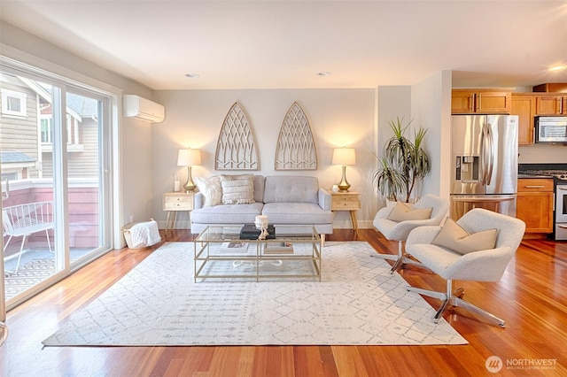 living room with recessed lighting, a wall mounted air conditioner, baseboards, and wood finished floors