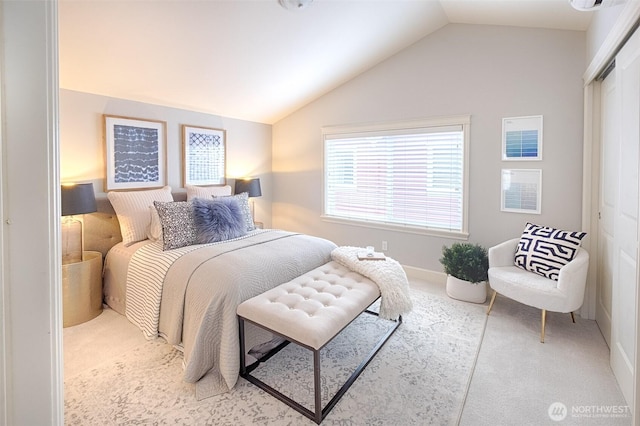 carpeted bedroom featuring a closet and lofted ceiling