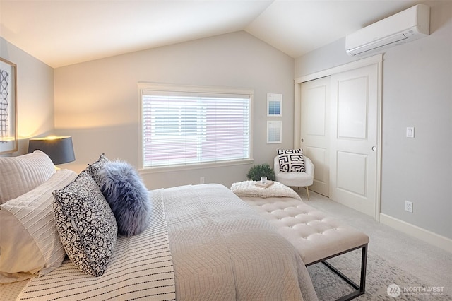 bedroom featuring baseboards, vaulted ceiling, a closet, a wall mounted air conditioner, and carpet flooring