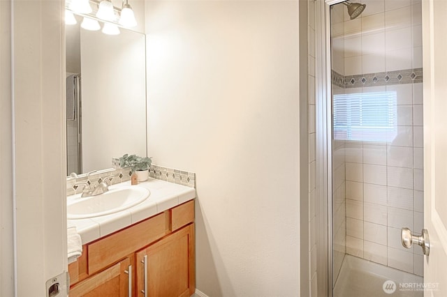 bathroom featuring vanity and a tile shower