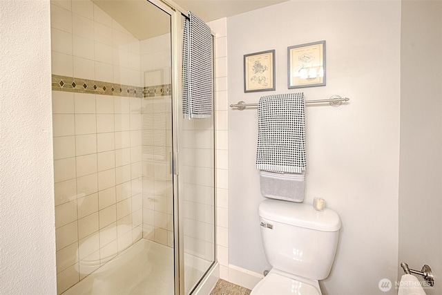 full bathroom with toilet and a stall shower