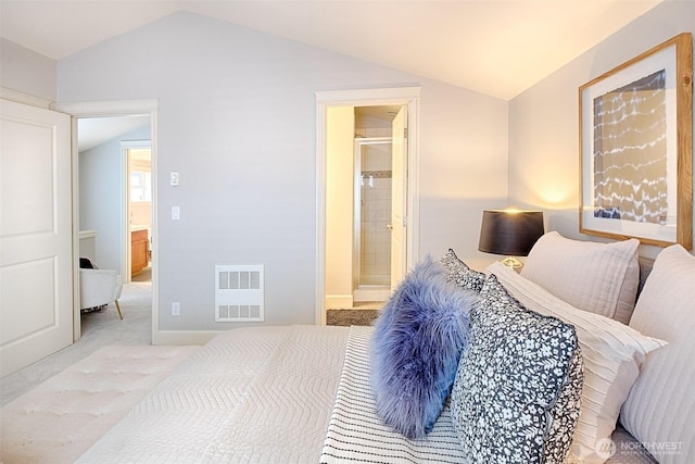 bedroom with lofted ceiling, carpet flooring, visible vents, and connected bathroom