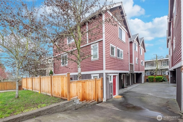 view of side of property with a lawn and a fenced front yard