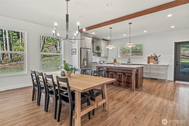 dining area featuring a notable chandelier, recessed lighting, baseboards, and light wood-style floors