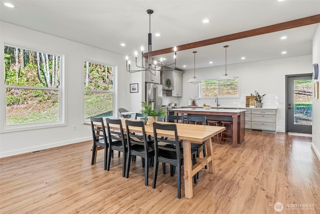 dining area featuring visible vents, plenty of natural light, and light wood-type flooring