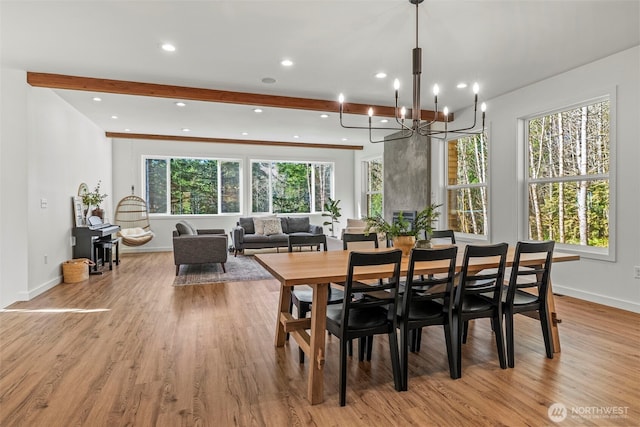 dining room with light wood finished floors, beamed ceiling, recessed lighting, and baseboards