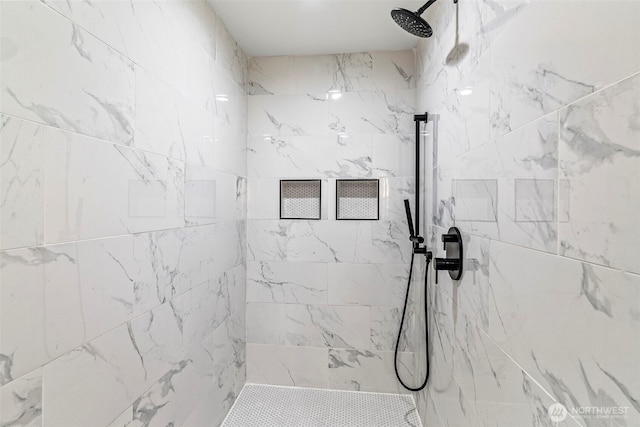 bathroom with a marble finish shower