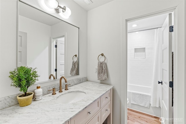 full bathroom with vanity, shower / bathtub combination with curtain, and wood finished floors