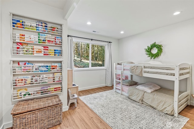 bedroom with recessed lighting, visible vents, baseboards, and wood finished floors