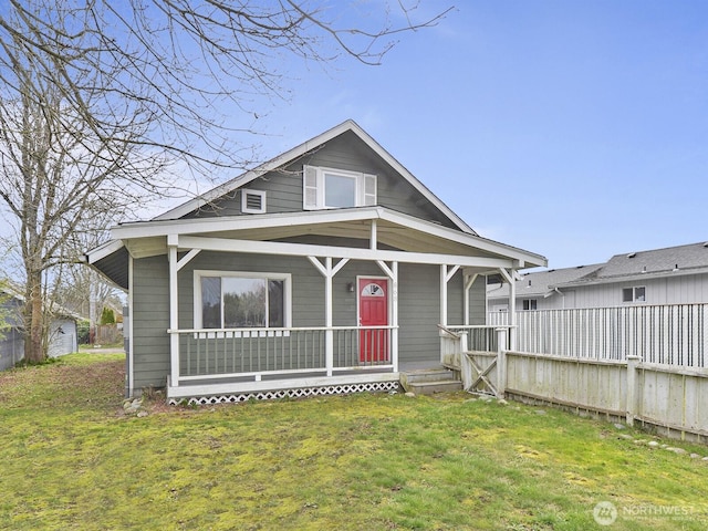 bungalow-style house with a front lawn and covered porch