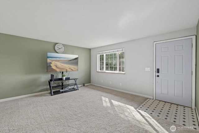 foyer with baseboards and carpet floors