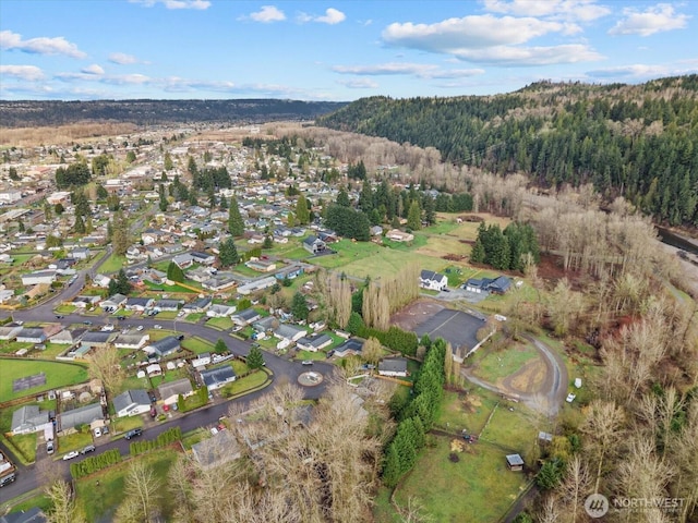 drone / aerial view with a residential view and a forest view