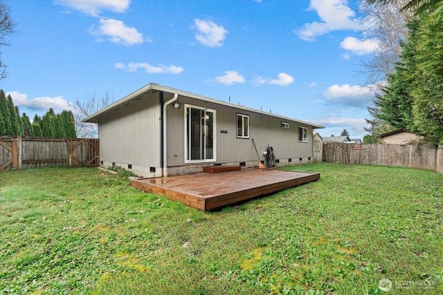 rear view of property featuring a wooden deck, crawl space, a yard, and a fenced backyard