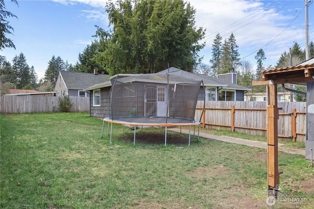 view of yard featuring a fenced backyard and a trampoline