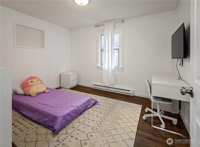 bedroom featuring baseboards, baseboard heating, and wood finished floors