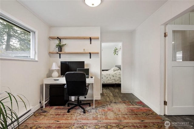 office space featuring baseboards and wood finished floors