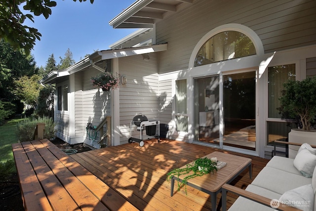 wooden terrace featuring outdoor lounge area and area for grilling