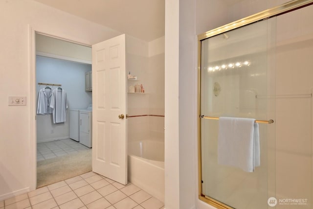 full bath with tile patterned floors, a bath, washing machine and dryer, and a stall shower