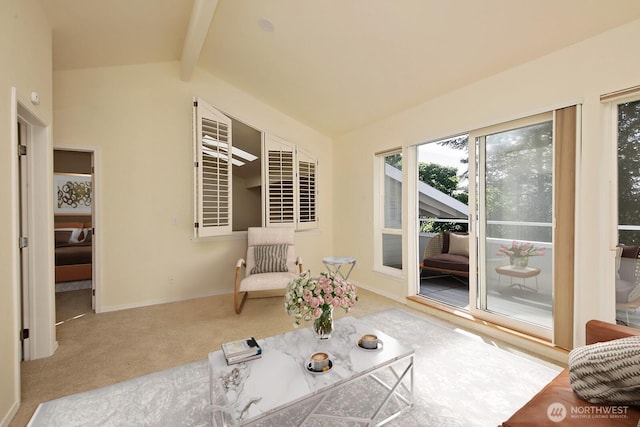 living area with lofted ceiling with beams and carpet