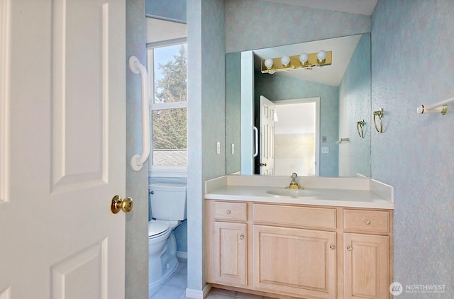 bathroom featuring vanity, vaulted ceiling, and toilet