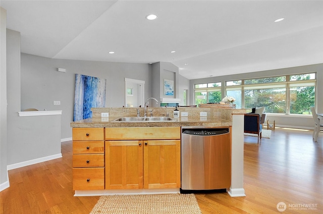 kitchen featuring a sink, stainless steel dishwasher, a healthy amount of sunlight, and vaulted ceiling