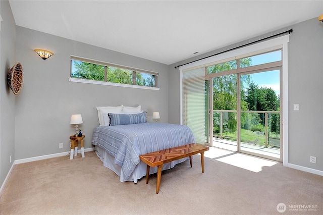 carpeted bedroom with access to exterior and baseboards