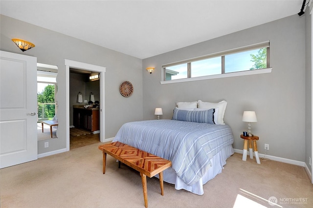 bedroom featuring light carpet, multiple windows, and baseboards