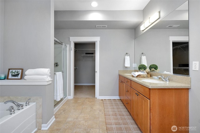 full bath featuring a sink, visible vents, a spacious closet, and a shower stall