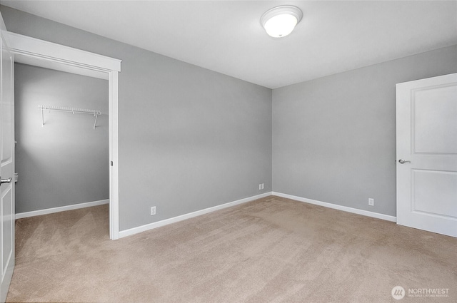 unfurnished bedroom with a closet, baseboards, and carpet flooring