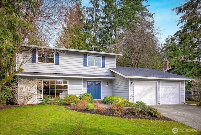 traditional-style house with a front yard, a garage, and driveway