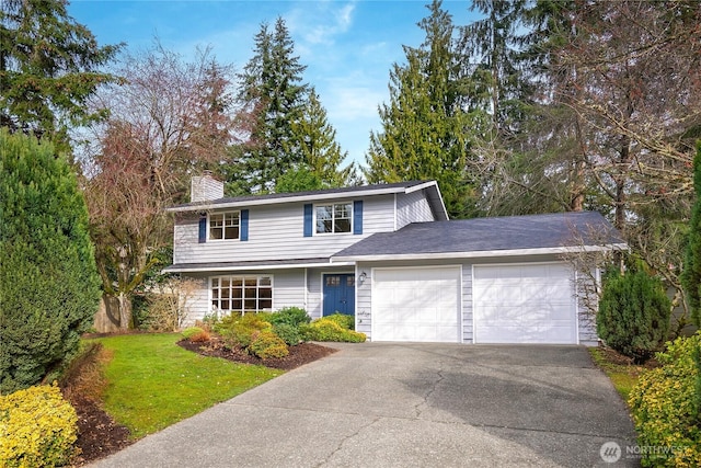 traditional-style house featuring a front lawn, an attached garage, driveway, and a chimney