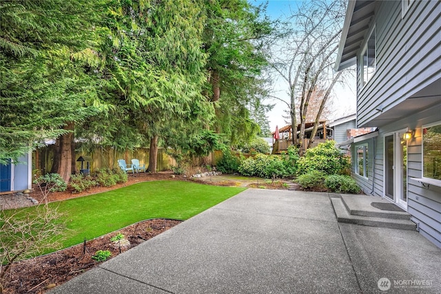 view of yard with a fenced backyard and a patio area