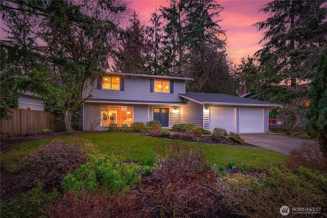 traditional-style home featuring fence, a chimney, a yard, a garage, and driveway