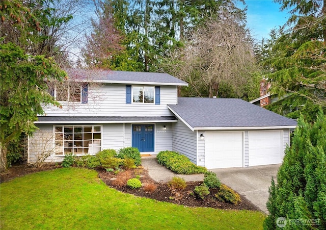 traditional-style home featuring a garage, concrete driveway, a front lawn, and a shingled roof