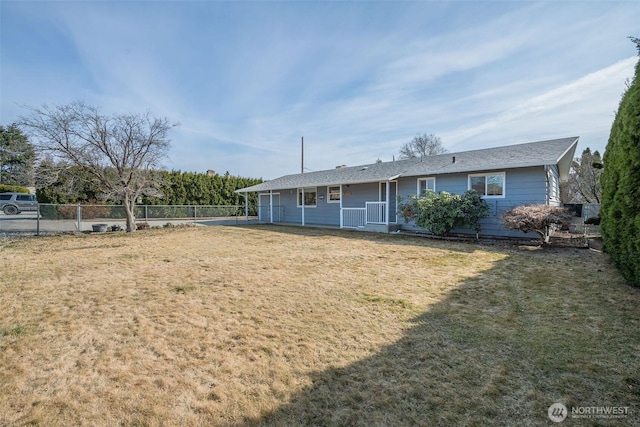 view of front of house with a front lawn and fence