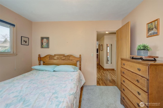 bedroom with visible vents and carpet