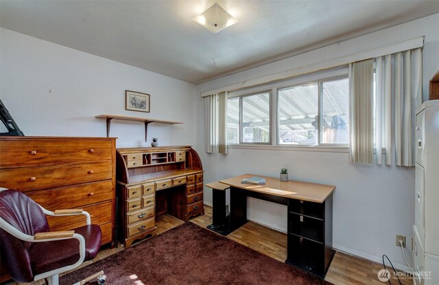 office featuring baseboards and light wood-type flooring