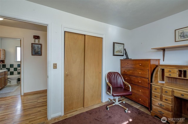 home office featuring wood finished floors and baseboards