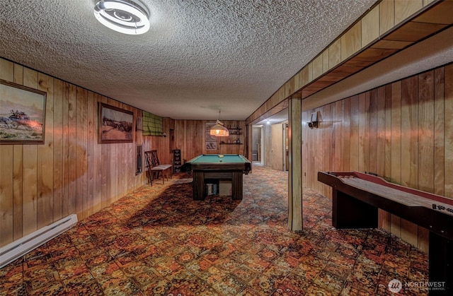 recreation room featuring billiards, a baseboard radiator, wood walls, a textured ceiling, and tile patterned floors