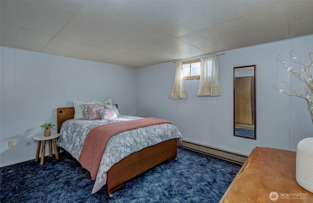 bedroom with a baseboard heating unit and carpet